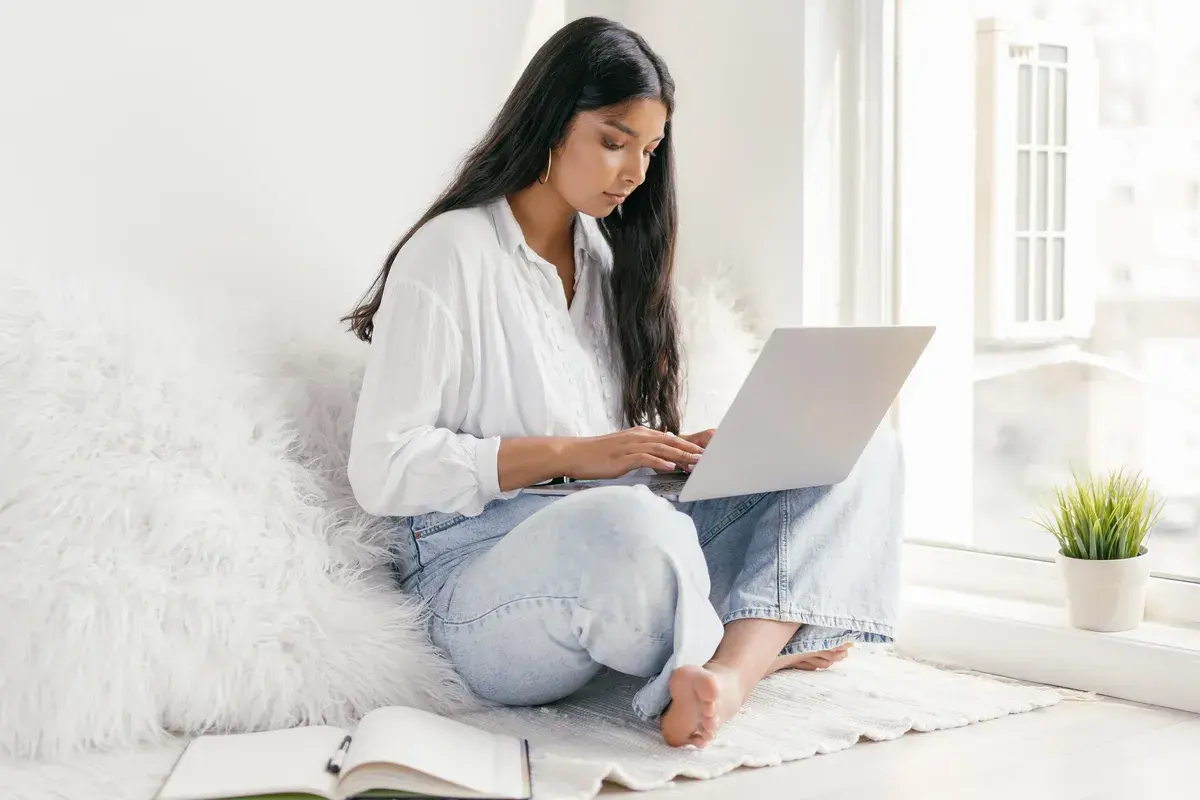 A student reading about residential mortgage regulation using her laptop