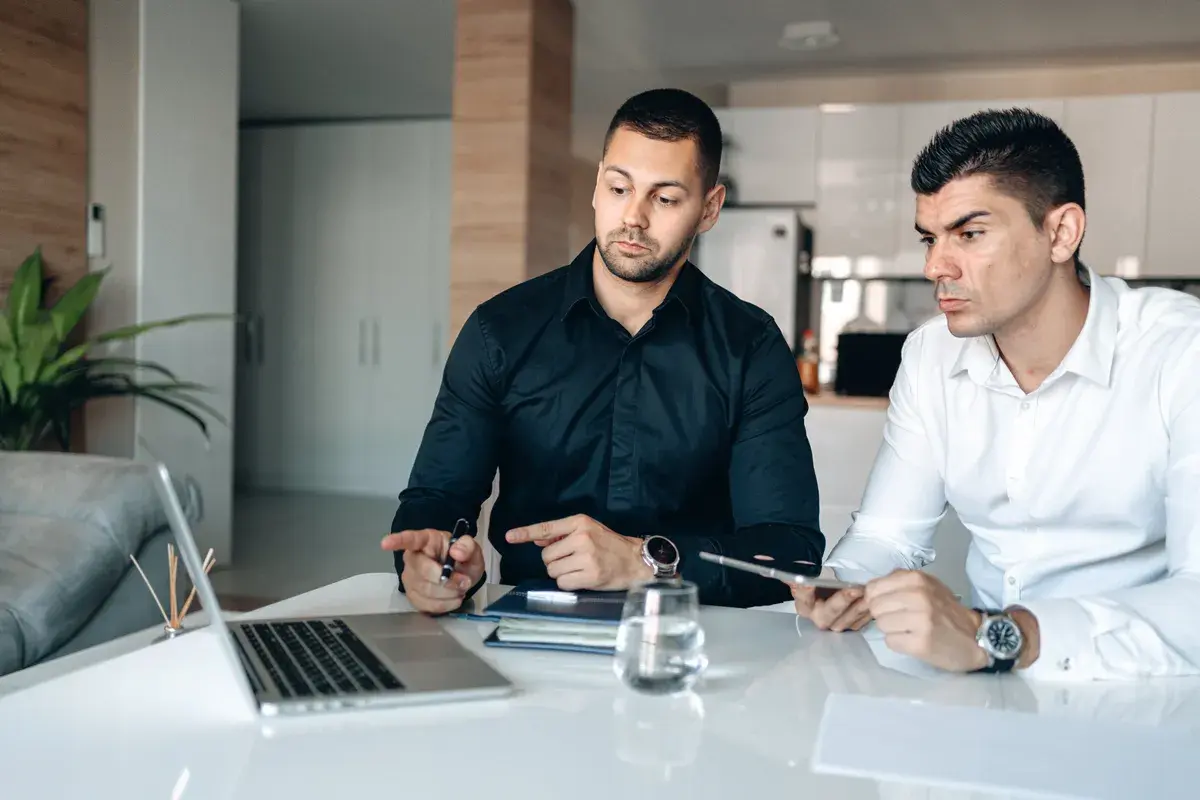 Men in long sleeves discussing how to build a strong client base