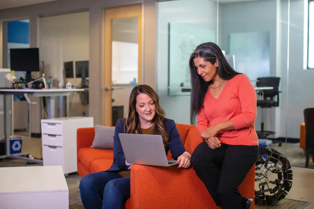 Woman having a smooth discussion with mortgage broker on a couch
