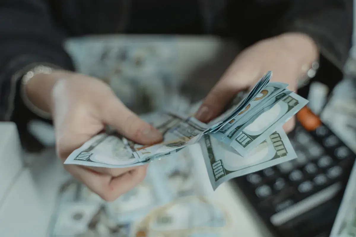 A person counting earnest money