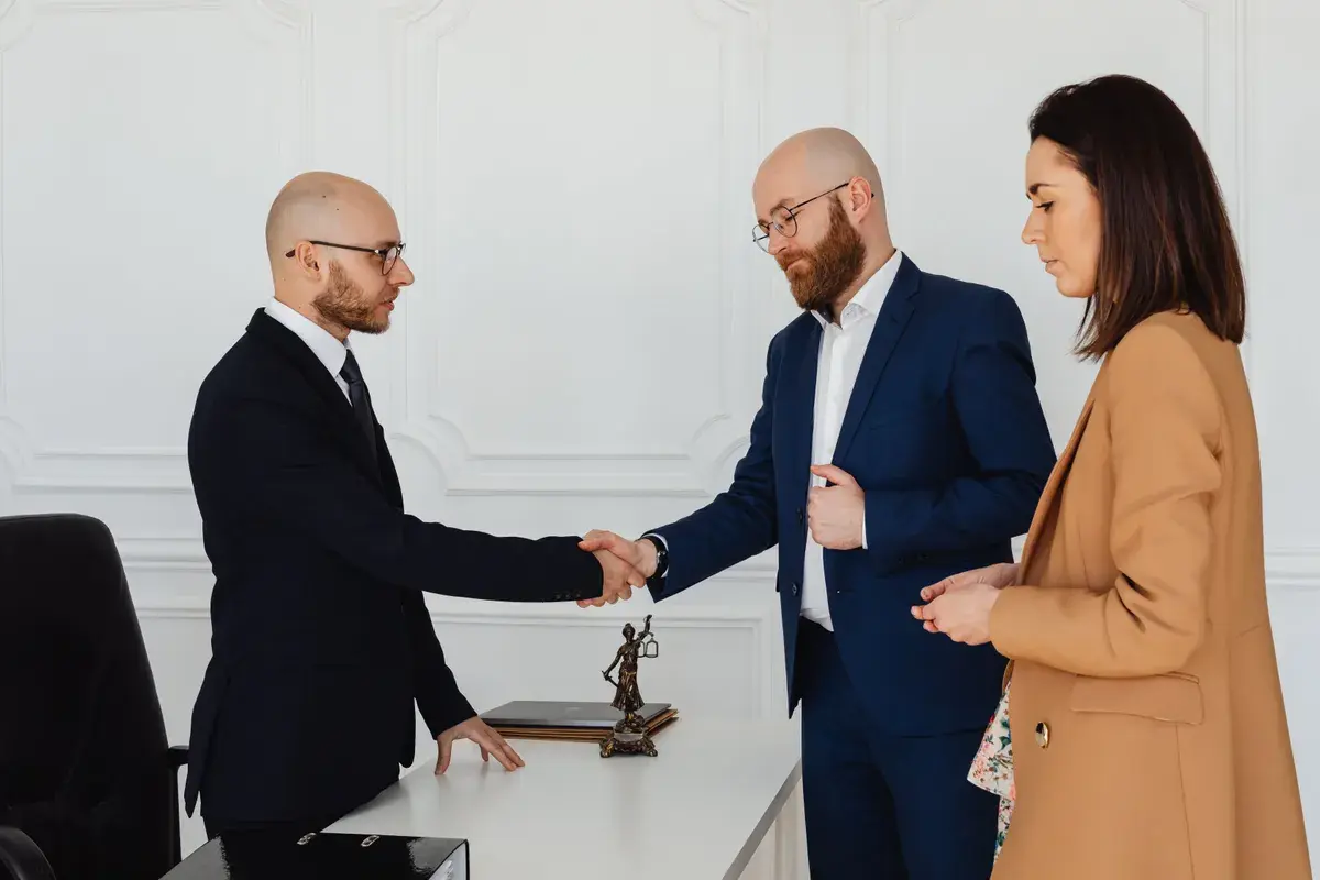 Husband shaking hand with a mortgage broker