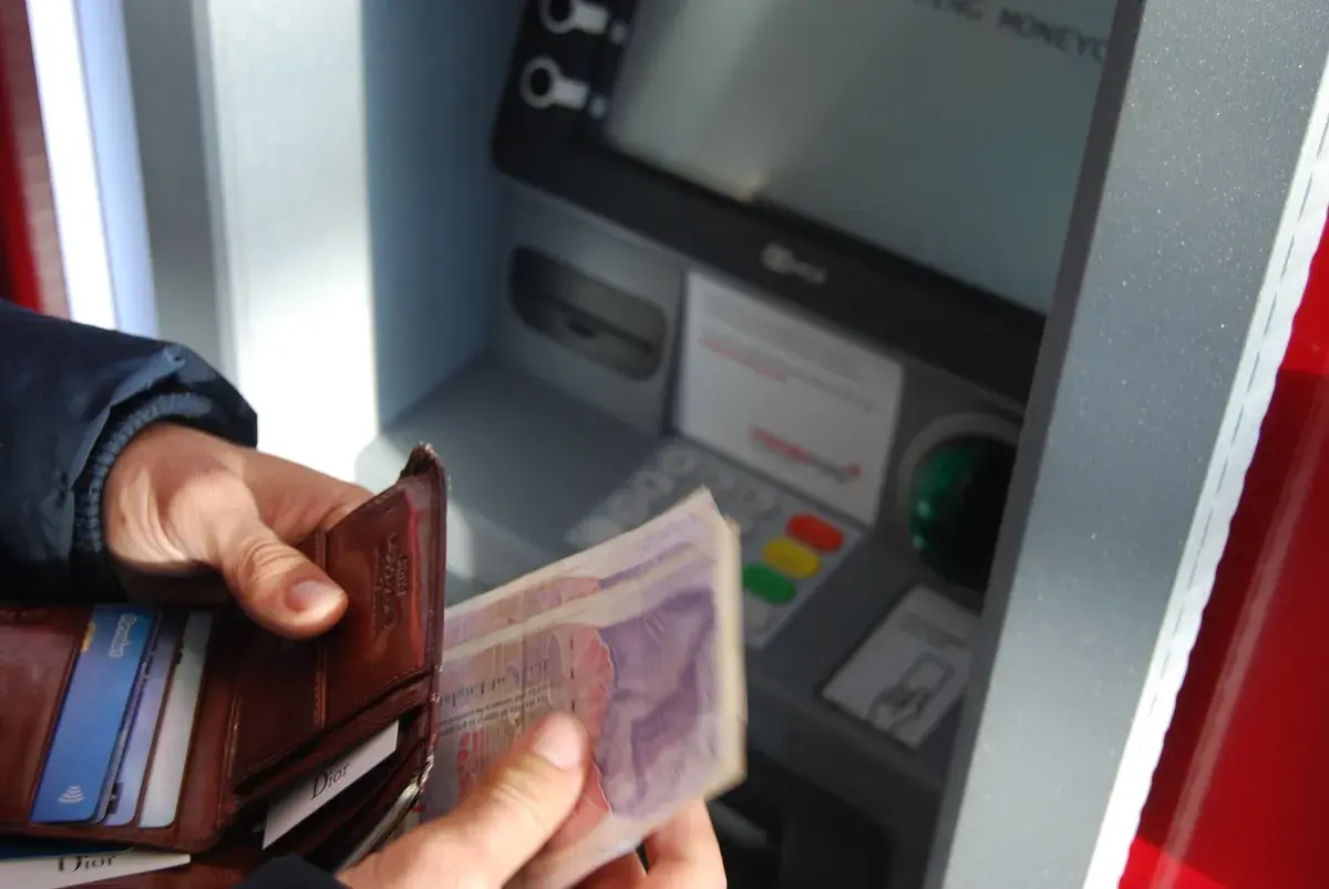 Homebuyer holding a leather wallet and payslips