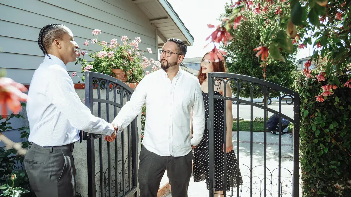 A mortgage broker shaking hands with his first client