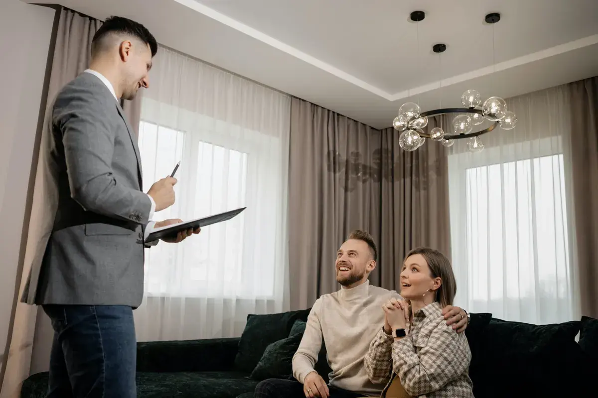 Couple sitting on a couch happily after finding the best mortagage broker