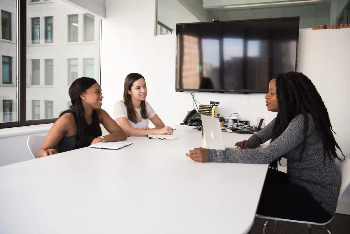Mortgage broker sitting a the table with clients