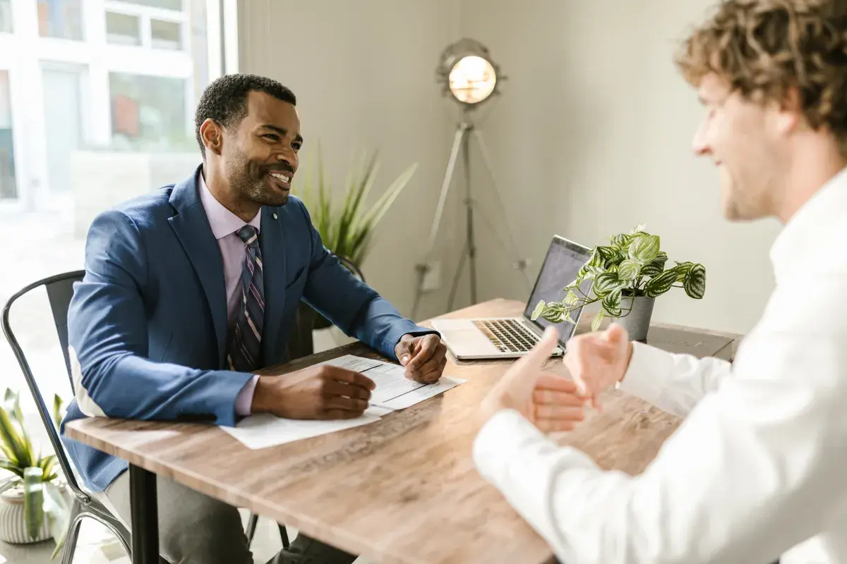 Lender sitting at table smiling