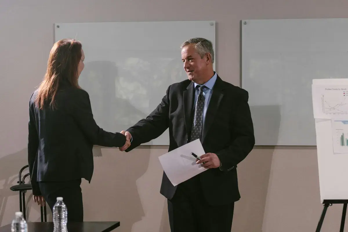 Broker shaking hands with client