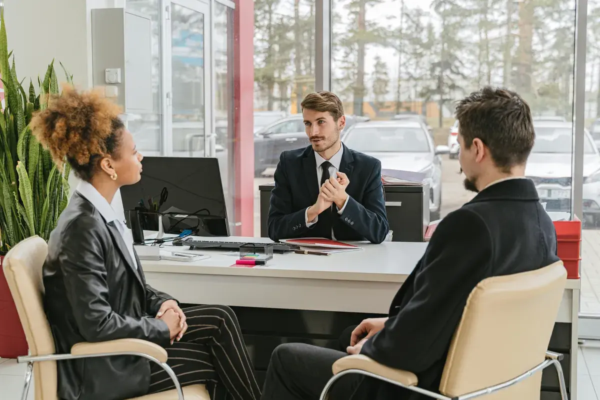 Broker talking with a couple in an office
